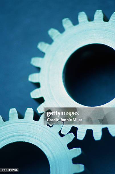 close-up of interlocking gears - two cogs stock pictures, royalty-free photos & images