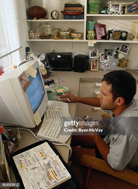 man squeezing a grip strengthener at his computer - ergonomic keyboard stock pictures, royalty-free photos & images