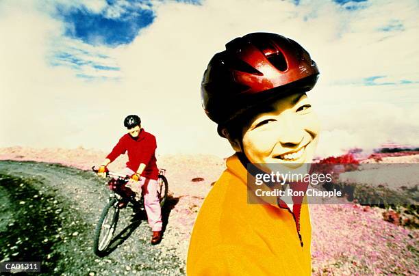 couple on trail with mountain bikes (cross processed) - cross processed imagens e fotografias de stock