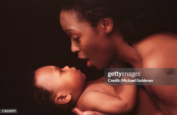 mother holding baby (9-11 months), close-up - michael virtue stock pictures, royalty-free photos & images