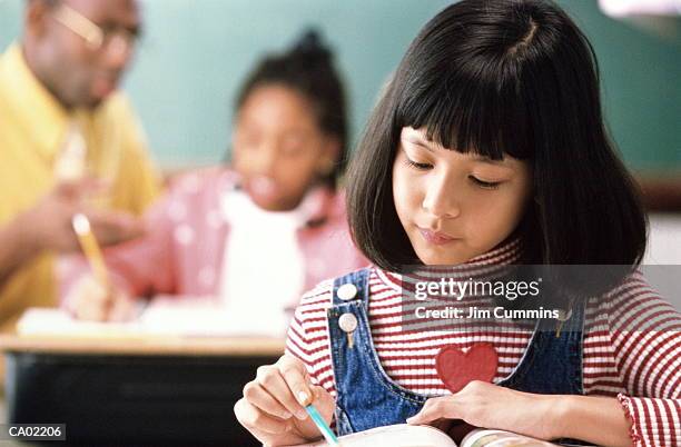 students (6-8) in classroom (focus on girl in foreground) - cummins stock pictures, royalty-free photos & images