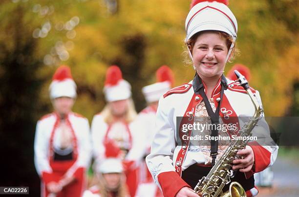high school marching band members on road in fall - saxaphone portrait photos et images de collection