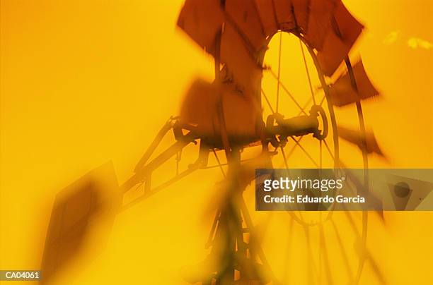 windmill, low angle view (yellow tone, soft focus) - 工業用風車 ストックフォトと画像
