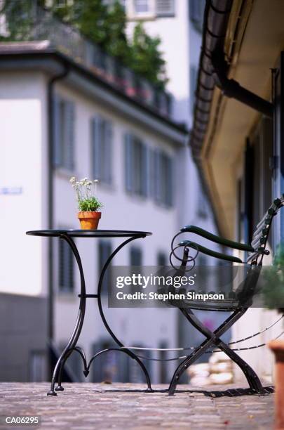 outdoor cafe table, chair & plant, zurich, switzerland - zurich cafe stock pictures, royalty-free photos & images