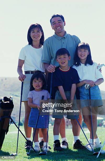 parents and children (4-12) standing on golf course, portrait - 12 23 months stock pictures, royalty-free photos & images