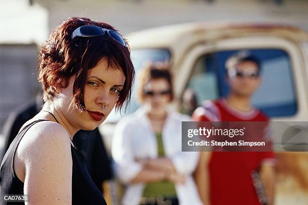 young  punk/grunge woman with nose ring, friends in back - nose ring stock-fotos und bilder