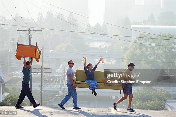 hispanic/amer friends moving sofa,woman on sofa with beer - four people stock pictures, royalty-free photos & images