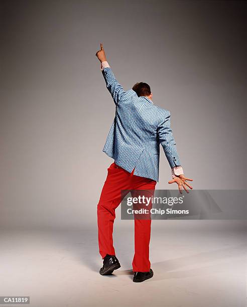 man wearing 1970's style clothes, striking disco pose, rear view - 20th century style stock pictures, royalty-free photos & images