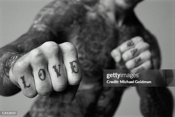 man's hands with tattoos reading 'love' and 'hate' - hate enskilt ord bildbanksfoton och bilder