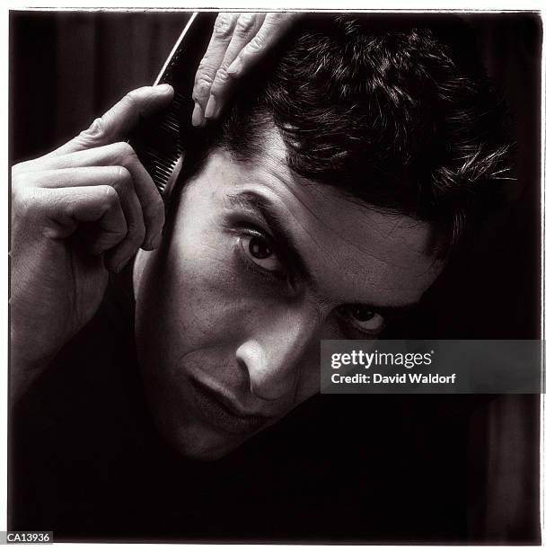 man combing hair, portrait, close-up (b&w) - waldorf fotografías e imágenes de stock