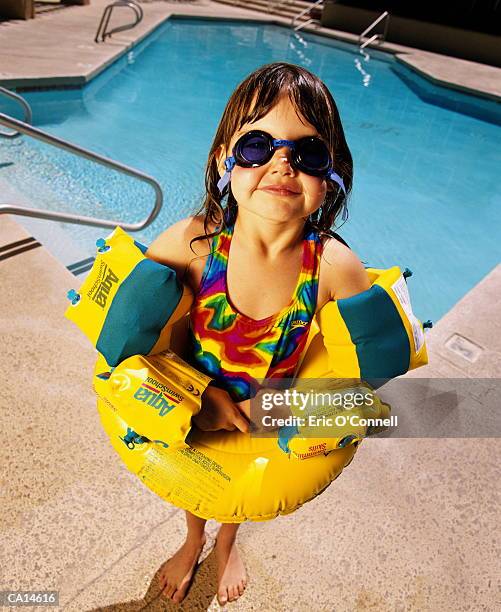 girl in flotation tube by pool - kids swimwear stock pictures, royalty-free photos & images