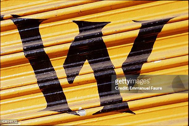 letter 'w' painted on metal shutter, close-up - w stock pictures, royalty-free photos & images