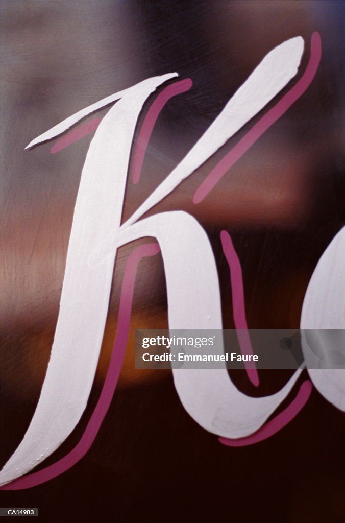 Letter 'K' painted on glass, close-up, low angle view