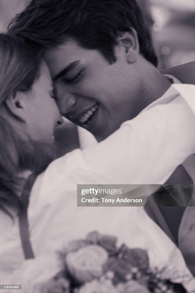 Young couple embracing, close-up, profile (B&W)