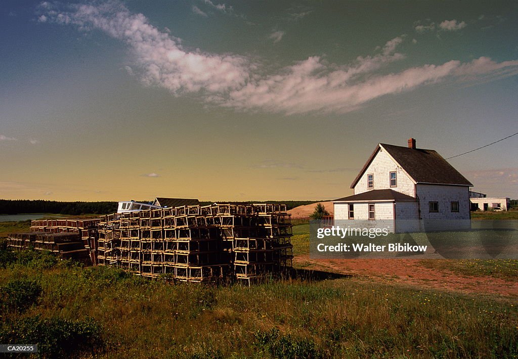Canada, Prince Edward Island, lobster pots stacked near house