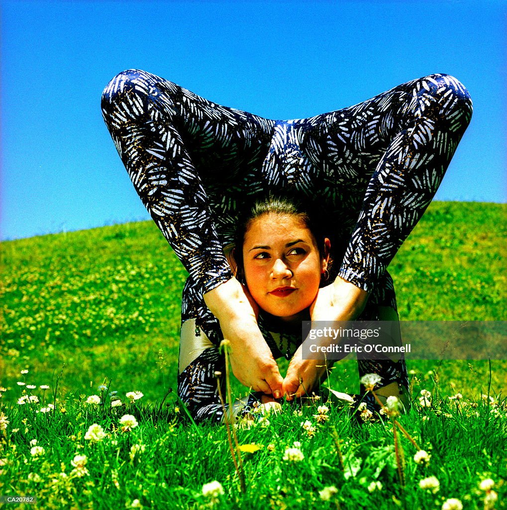 Female contortionist in field