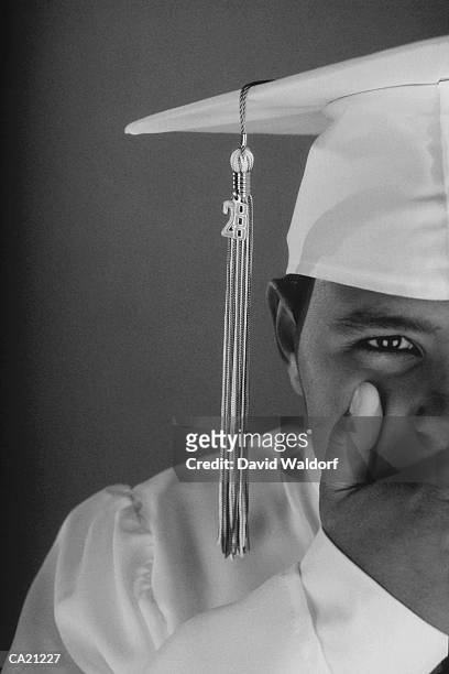 teenage boy (12-14) in cap and gown, covering mouth (b&w) - waldorf fotografías e imágenes de stock