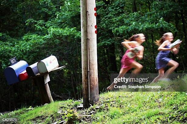 two excited girls running home with the mail - simpson address stock pictures, royalty-free photos & images