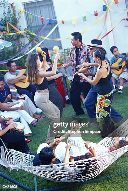 hispanic americans having salsa party in backyard - americans stockfoto's en -beelden