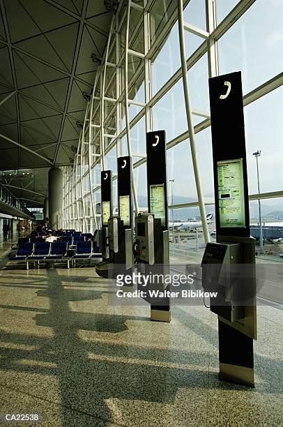 china, hong kong, chek lap kok airport, public phones in terminal - kok stock pictures, royalty-free photos & images