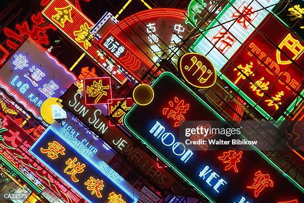hong kong, kowloon, neon signs illuminated at night - china economy stock pictures, royalty-free photos & images