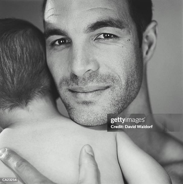 father holding baby boy (21-24 months), close-up (b&w) - waldorf fotografías e imágenes de stock