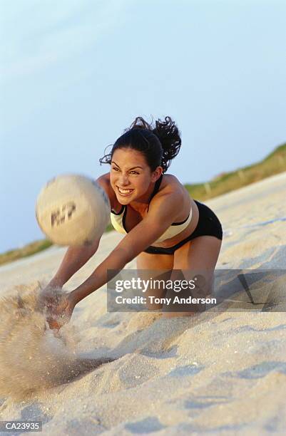 woman playing beach volleyball - womens beach volleyball stock-fotos und bilder