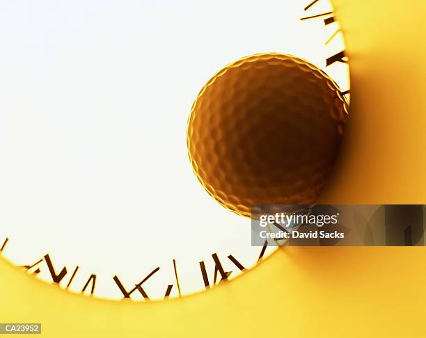 golf ball on edge of hole, view from inside hole - golf ball hole stock pictures, royalty-free photos & images