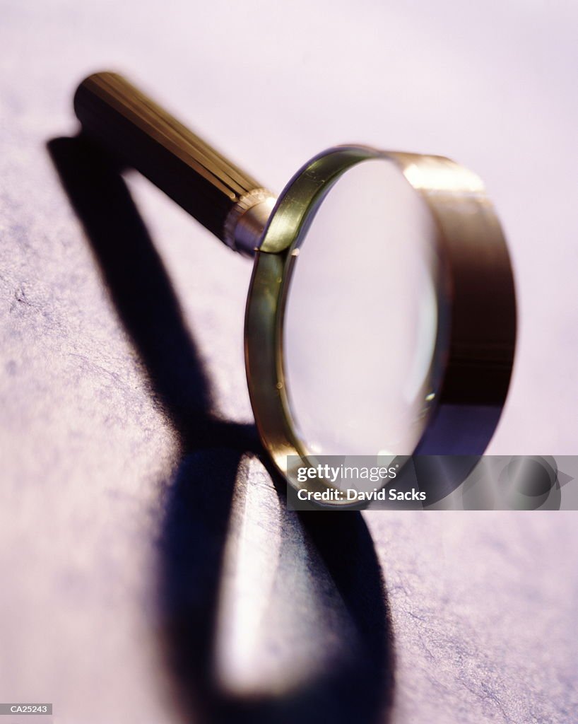 Magnifying glass balancing on it's edge