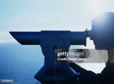 Man using telescope, profile Man using telescope, profile