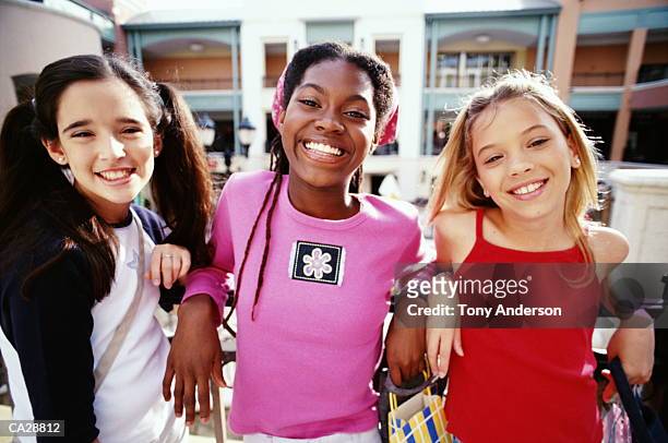 multi-racial girls (10-12) in shopping mall - nur mädchen stock-fotos und bilder
