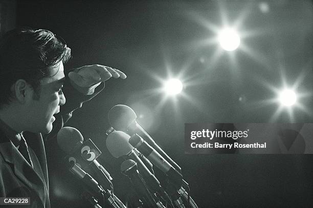 man shielding eyes at press conference, profile (b&w) - political press conference stock pictures, royalty-free photos & images