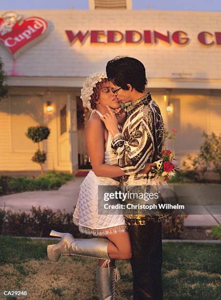 newlyweds kissing outside wedding chapel, las vegas, nevada, usa - vegas wedding stock pictures, royalty-free photos & images