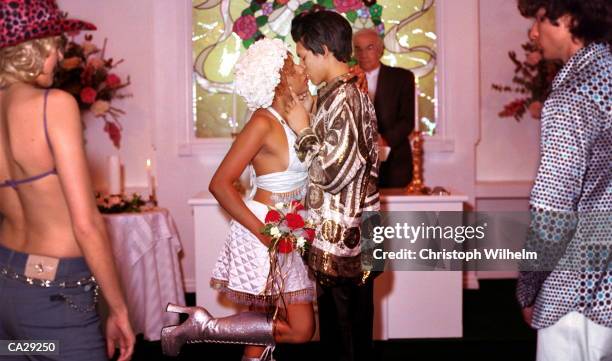 newlyweds kissing in wedding chapel, friends watching - chapel bildbanksfoton och bilder