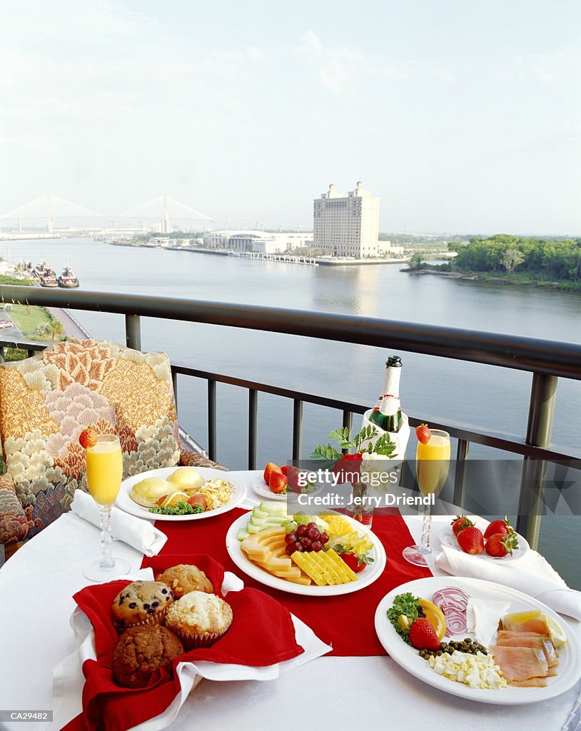 Brunch laid out on table, hotel balcony, elevated view