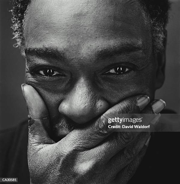 mature man smiling, covering mouth, portrait, close-up (b&w) - waldorf stock pictures, royalty-free photos & images
