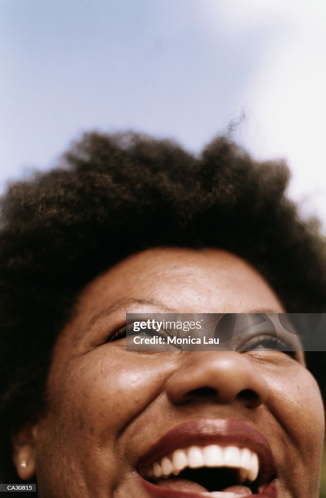 MATURE WOMAN LAUGHING OUTDOORS, CLOSE-UP