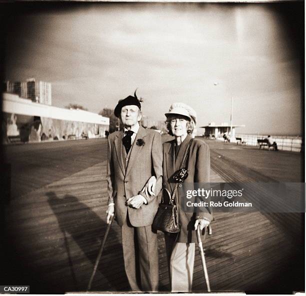 elderly couple on boardwalk, portrait (b&w sepia tone, vignette) - sunday best stock pictures, royalty-free photos & images