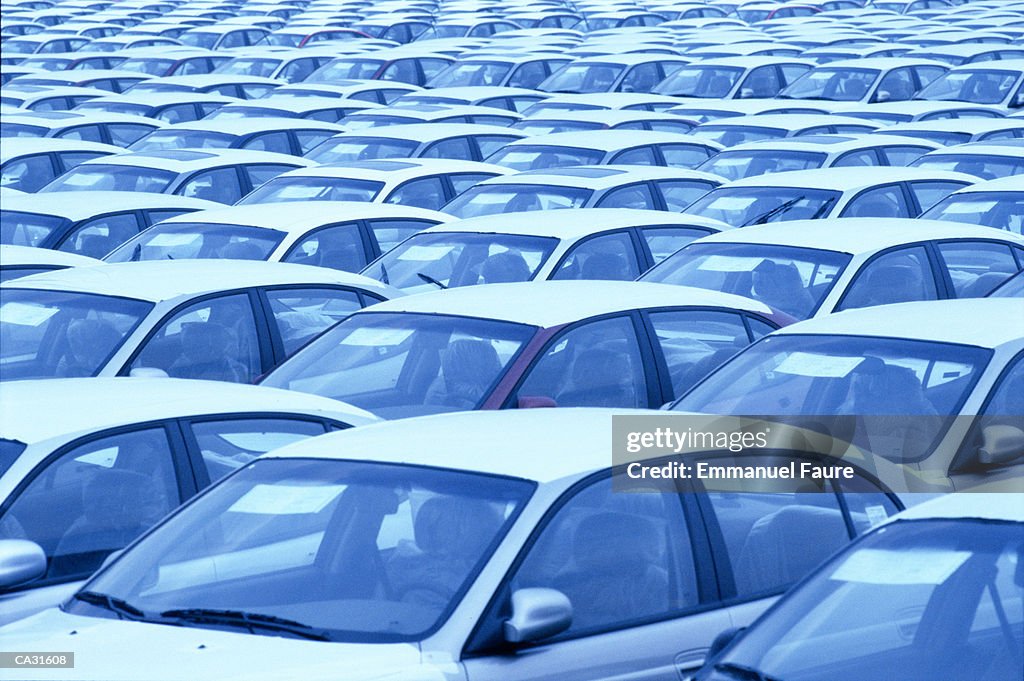 Imported cars in parking lot, full frame (blue tone)