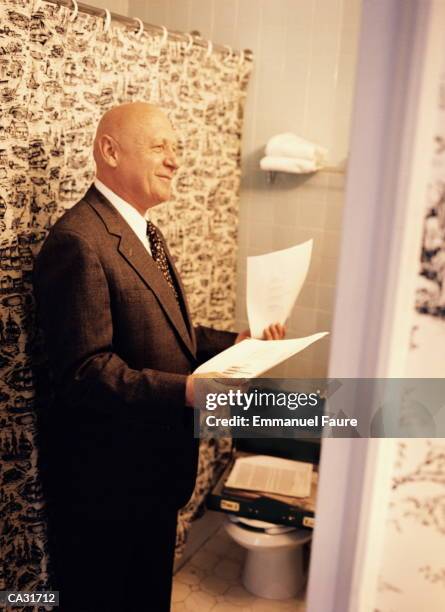 mature businessman practicing presentation in hotel room - asta per le tende foto e immagini stock