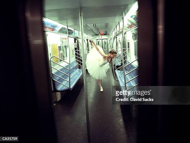 ballerina practicing in subway car - fehl am platz stock-fotos und bilder