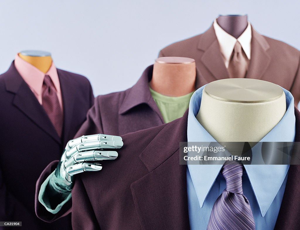 Female mannequin's hand resting on male suit shoulder