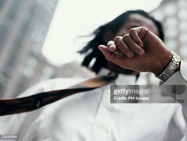 usa, new york city street businessman looking at watch - usa city stock pictures, royalty-free photos & images