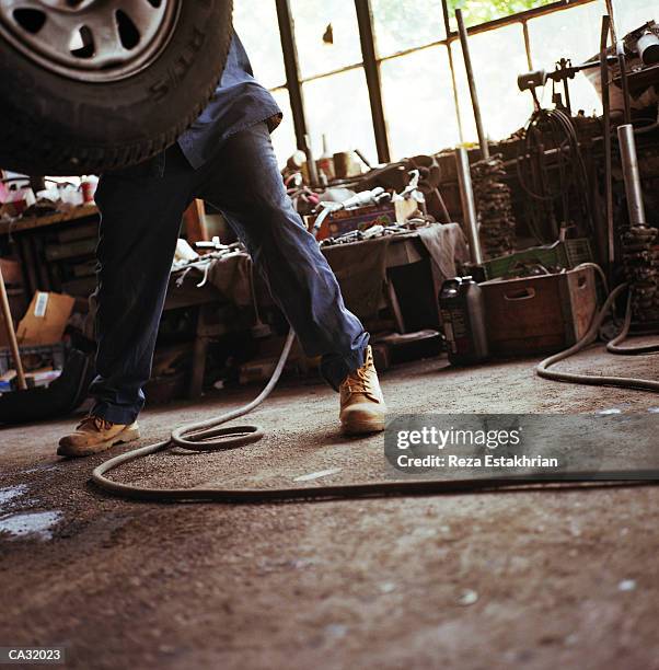 auto mechanic working on car in garage, low section - car mechanic stock pictures, royalty-free photos & images