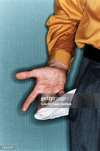 man pulling out trouser pocket lining, close-up - inside out stock pictures, royalty-free photos & images