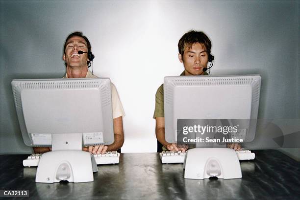 Two Guys Computer Laughing Two People One Computer Photos and Premium High Res Pictures ...
