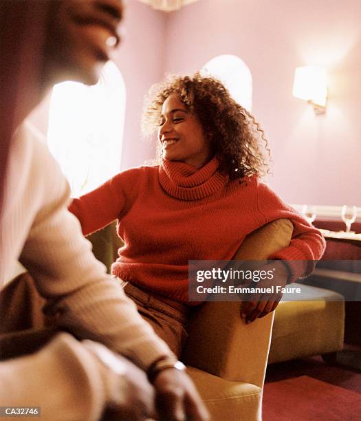 young couple smiling in cafe (focus on woman) - emmanuel stock pictures, royalty-free photos & images