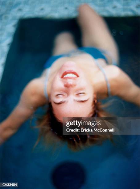 young woman floating in pool, close-up - ericka stock pictures, royalty-free photos & images
