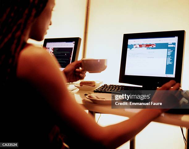 young woman sitting in internet cafi - emmanuel stock pictures, royalty-free photos & images