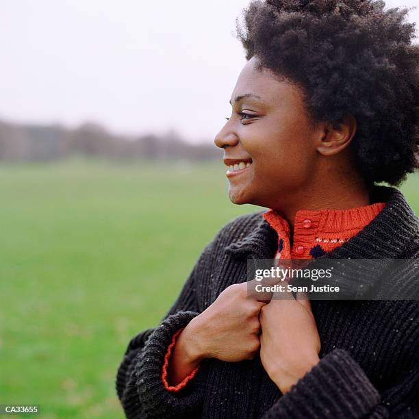 young woman smiling in park,   profile, close-up - facing things head on stock pictures, royalty-free photos & images